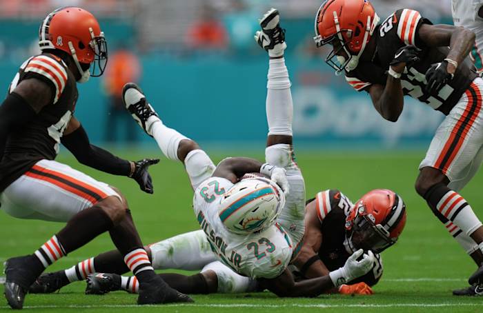 Miami Dolphins Elijah Campbell (22) gets up-ended by Cleveland Browns safety Grant Delpit (22). © JIM RASSOL/THE PALM BEACH POST / USA TODAY NETWORK